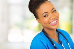 bigstock-happy-african-nurse-looking-at-62797147-2